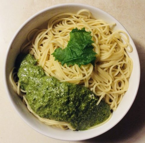 Spring Weed Queen's Garlic Mustard Pesto, Presented with Leaf, Beige Background